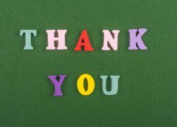 Thank you lettering on a green background.